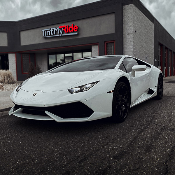 white luxurious car outside of shop